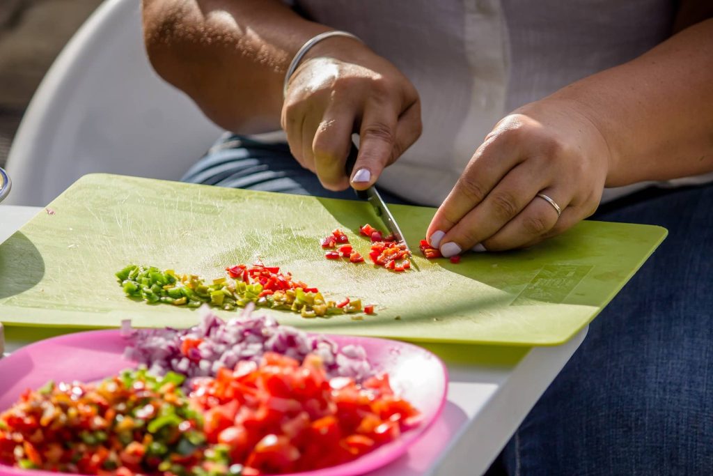 Cutting salad ingredients on a plastic cutting board