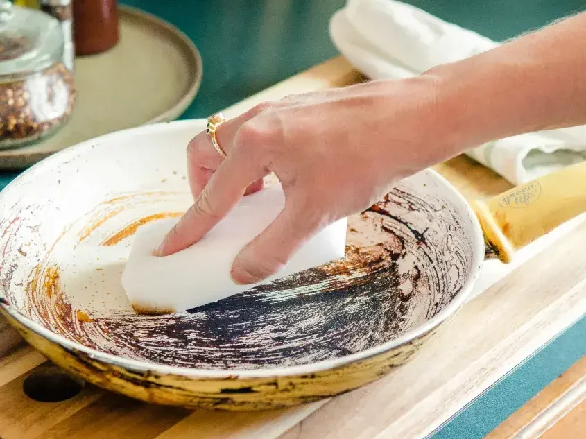 Wiping a burnt ceramic pan clean