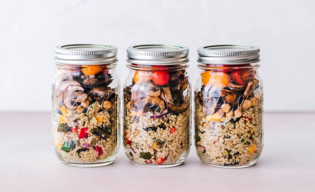 Glass container mason jars with salads inside