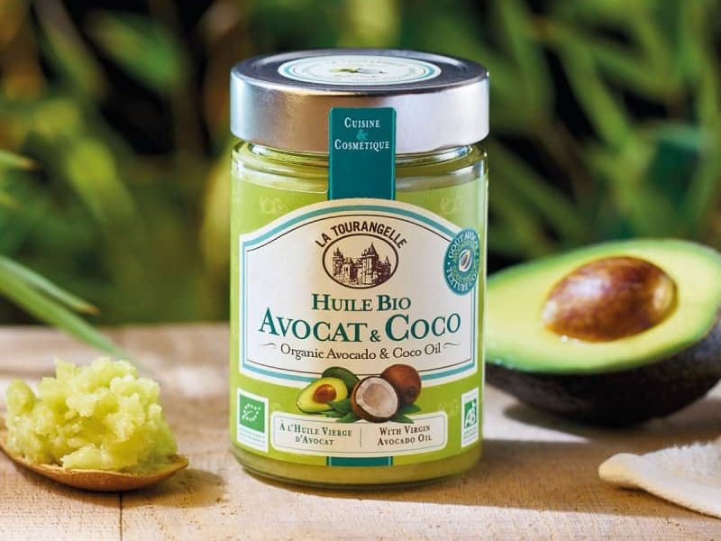 A glass jar of organic avocado and coconut oil for cooking