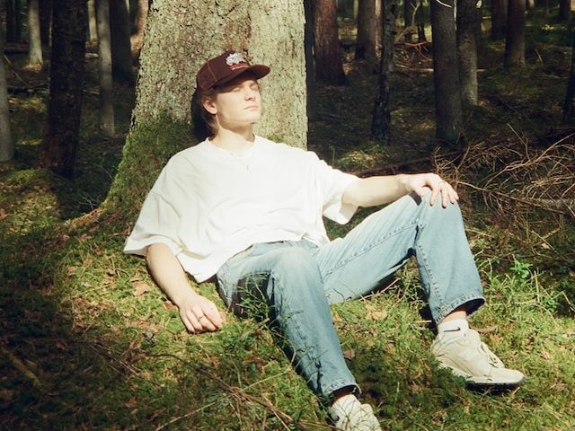 guy sunbathing in forest