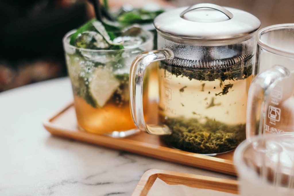 A glass tea infuser filled brewing tea