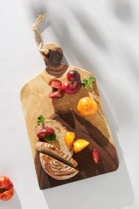 non toxic cutting board in wood with tomatoes on top