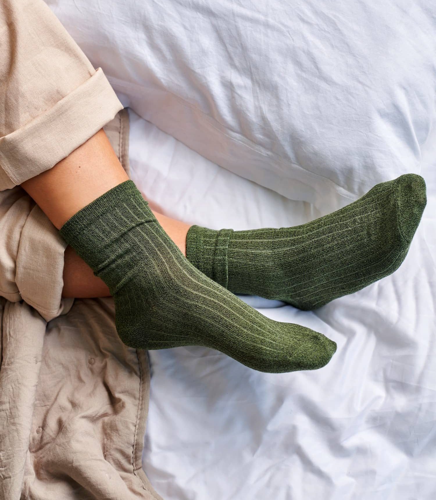 a pair of green tourmaline socks on feet